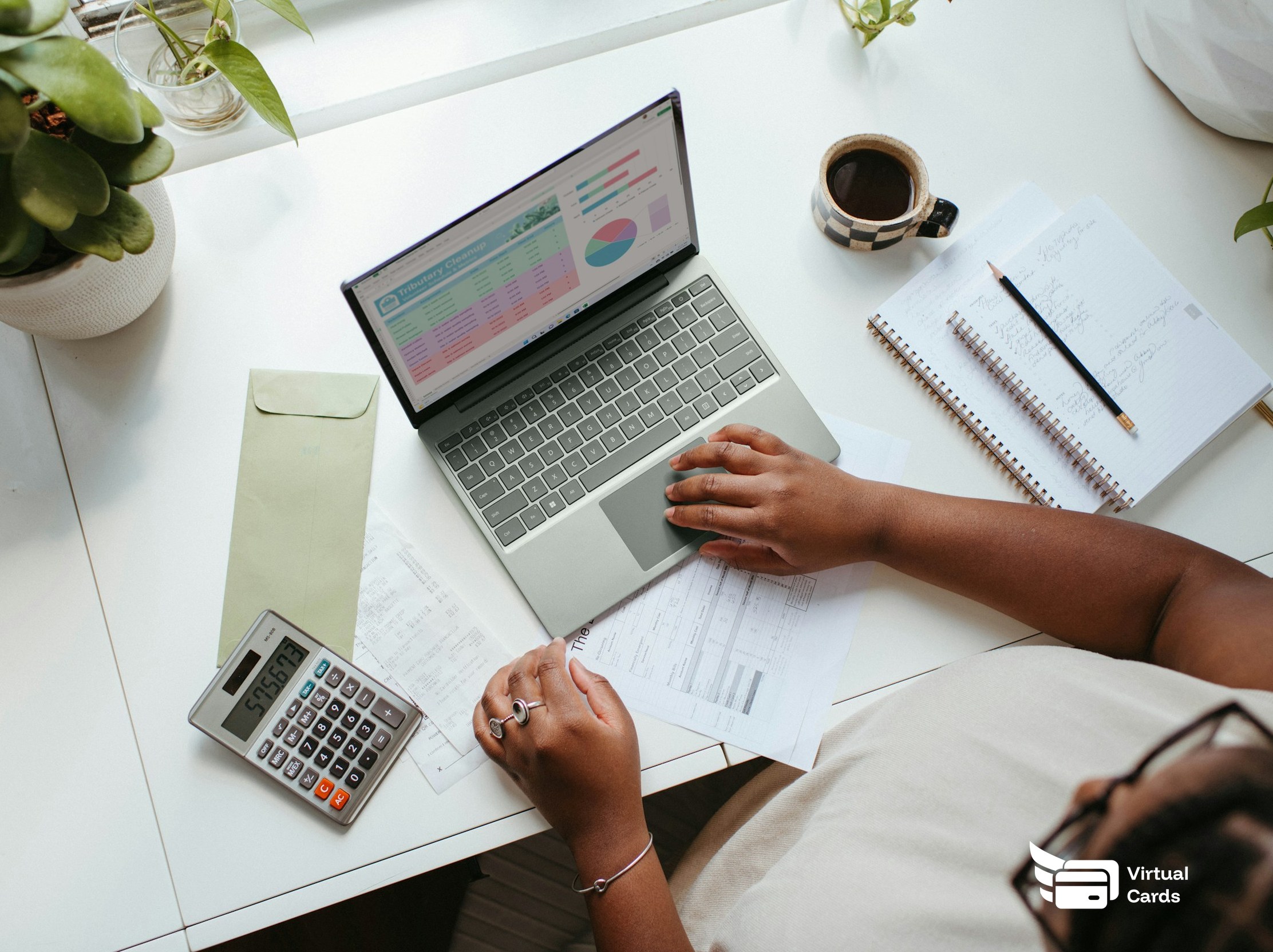 A person cross-checking a laptop spreadsheet against a printed bill and calculator at a desk, deciding how to size and structure a new spending card.